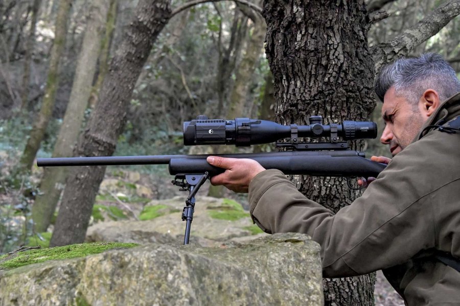 Nachtzieltechnik und Nachtsichttechnik im jagdlichen Einsatz. Was ist erlaubt, was ist verboten? Schütze mit Gewehr im Anschlag darauf montiert ein Pulsar Forward F.