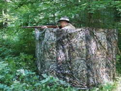 Tipps für die Krähen- und Taubenjagd und Lockjagd auf Federwild Jäger schießt aus Tarnstand mit Tarnnetz in Realtree®