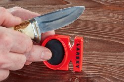 Messer unterwegs Schärfen: 4 Mini-Messerschärfgeräte im Test  Lansky Quick Fix Knife Sharpener mit Messer im Bild.