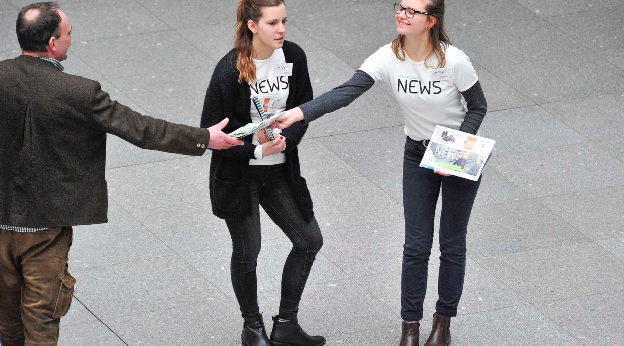 Handing papers at IWA 2016