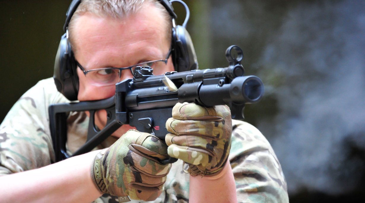 Shooter holding a stocked Heckler & Koch SP5K pistol