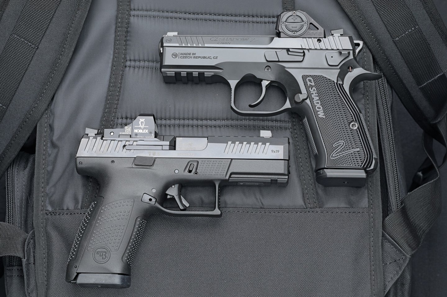 CZ Shadow 2 Carry & P10-C Ported auf einem Rucksack liegend.