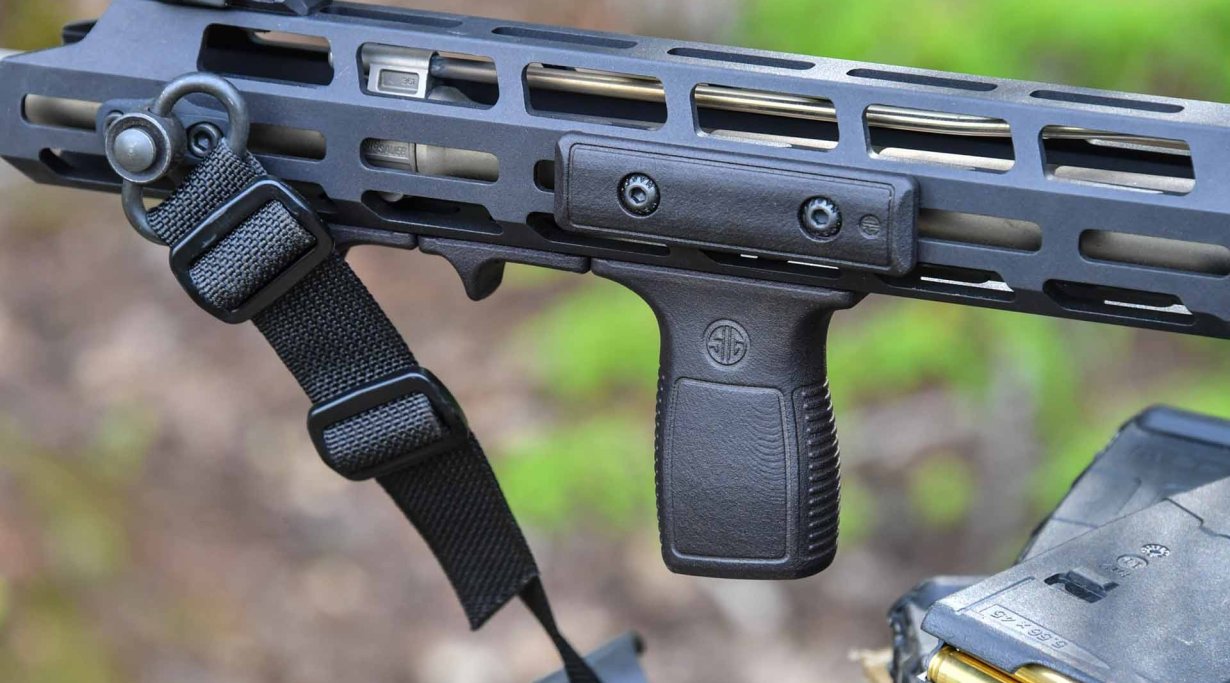 The optional vertical foregrip of the SIG Sauer M400 TREAD, mounted with ad...