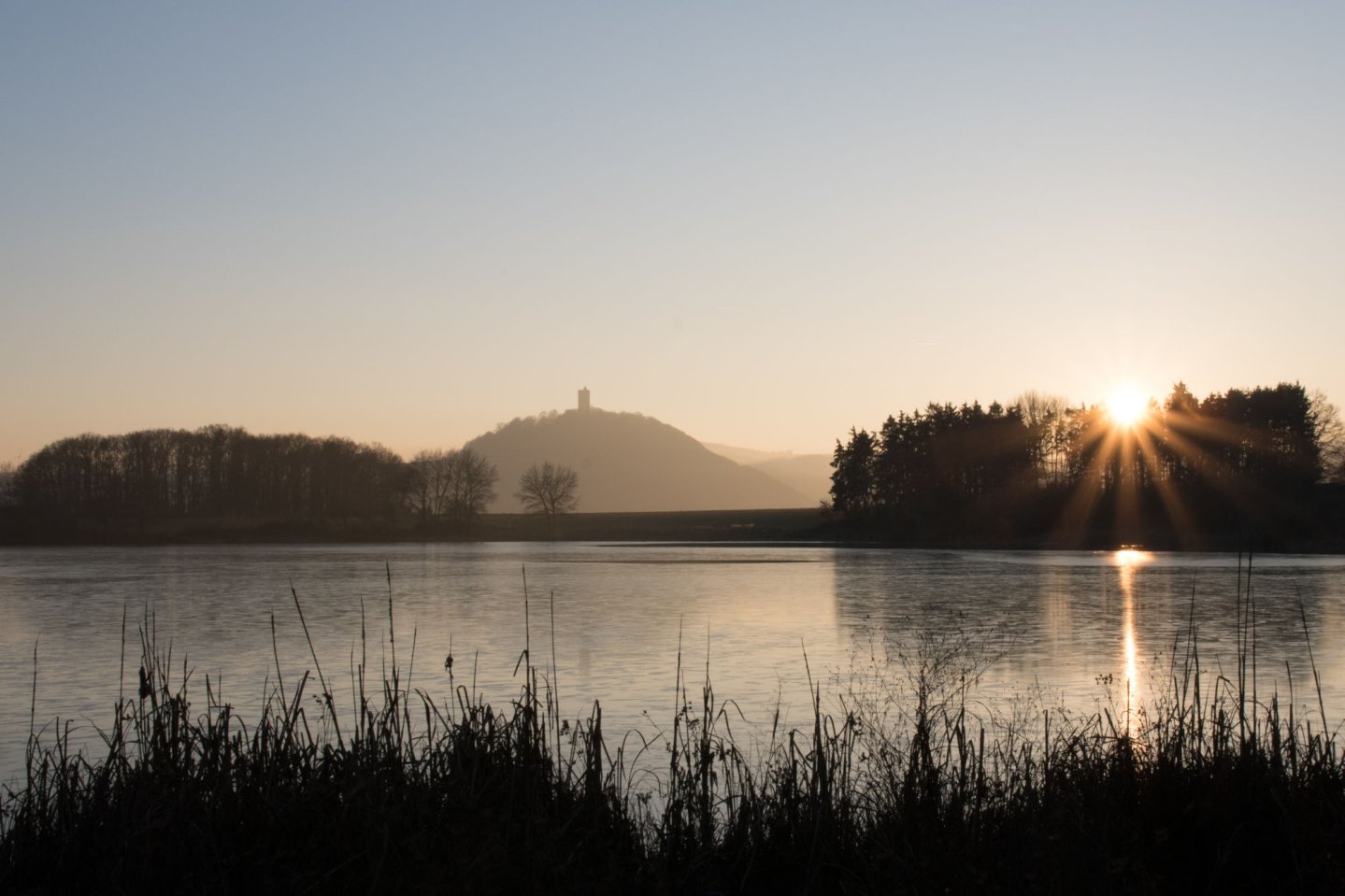 Rodder Maar with Olbrück castle in the background just before sunset