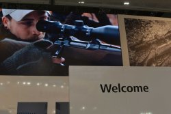 ZEISS at the IWA 2019: Hunting App and new brand campaign Huge image of a hunter with rifle looking through a ZEISS riflescope.