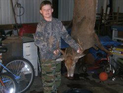 White-tailed Deer hunting in Illinois, USA Tyler Brenner aged 8 with his first white tailed buck.