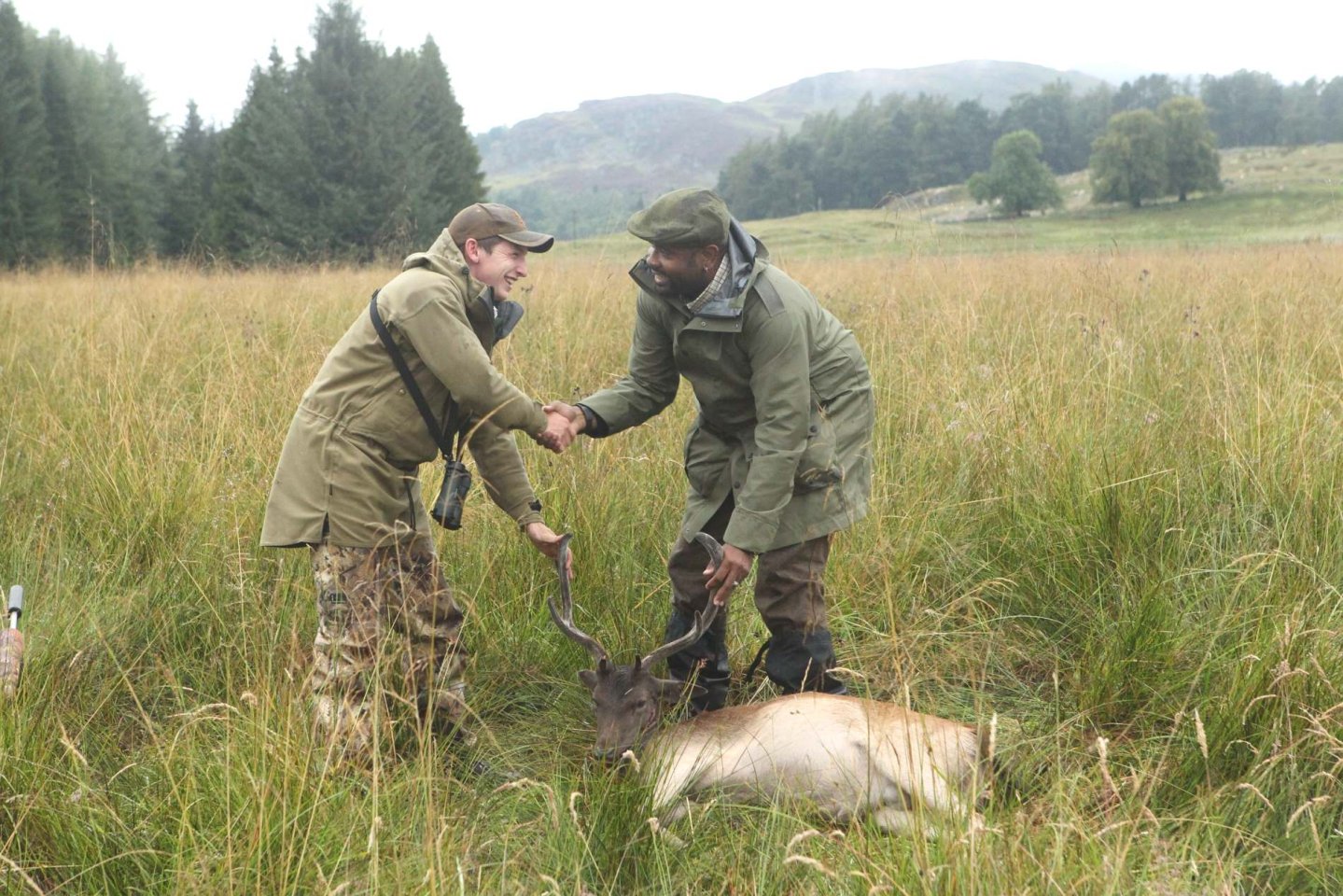 Preparation for shooting and hunting in the UK Deerstalkers shaking hands with client at end of stalk