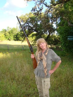 Lady hunter, clay shot, instructor and international game shot Lady shooter with 20 gauge side by side hammer gun