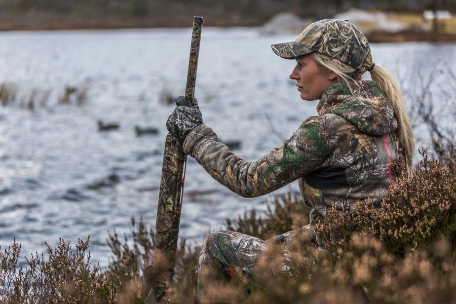 Lady Hunter: a "wild grouse" from Norway Lady hunter looking at the river holding the semi auto shotgun Winchester SX3