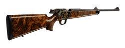 Blaser R8 OWN, a special edition rifle with gold inlaid action and diamonds The steel receiver presents the World Hunting Exhibition “One With Nature” (OWN) logo.