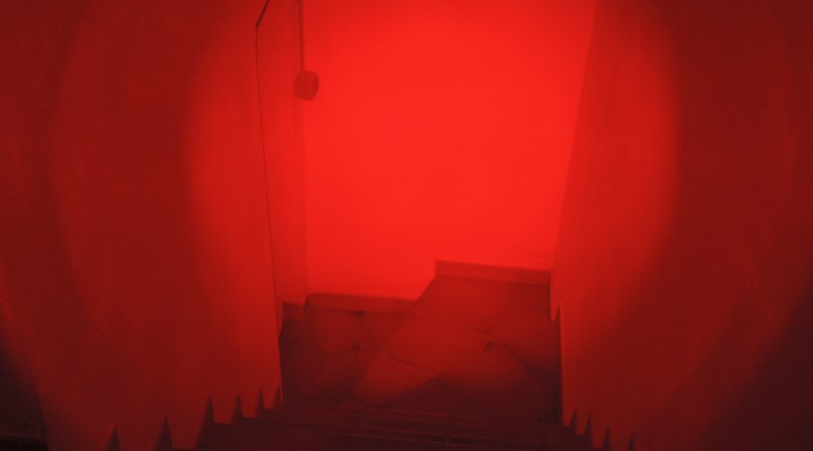 Corridor illuminated by the red navigation LED of the MFT Torch Backup tactical gunlight