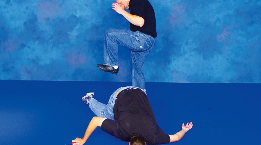 Two men demonstrate the defense to ward off a knife attack with their bare hands. 
