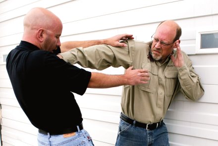 Self-defense and unarmed defense - Part 2: efficiency and the "stranglehold" attack A man punches an attacker with his fingertips against the larynx. from the two perspective