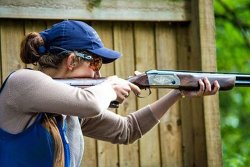 A young, competitive shooting champion and huntress Hannah Gibson during clay shooting