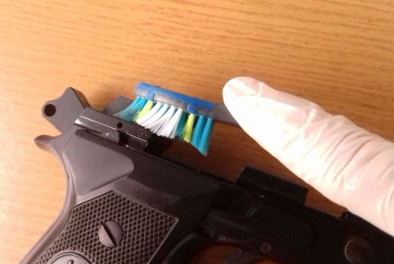 Cleaning residues from the mechanisms and internal surfaces of frame and slide of a pistol