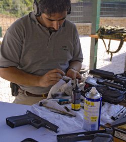When to clean a gun? Guy cleaning a gun