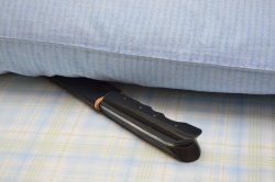 Is it bad luck to give a knife as a gift? Well, no. knife with a black handle under the pillow