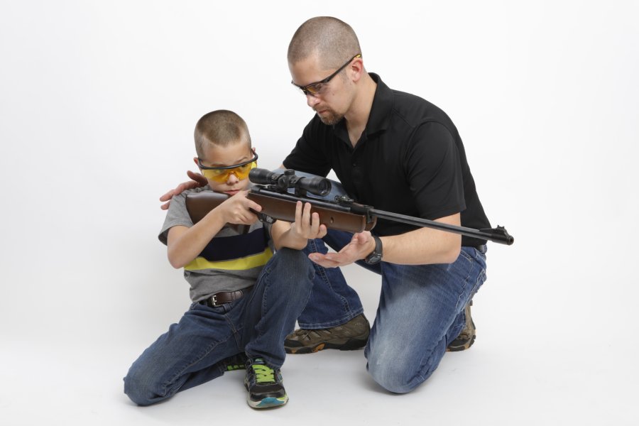 EU gun ban: FACE's press release attacks the Dutch Presidency An instructor teaching a young shooter to handle and aim an air rifle