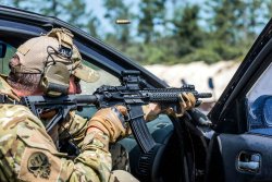 New Aimpoint CompM5 sight presented at DSEI Soldier holding a rifle with a sight