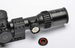 Schmidt & Bender PM II 3-20x50 LP Double Turn, a great German riflescope A commercial CR2032 seated in the brightness adjustment dial of the Schmidt & Bender PM II 3-20x50 LP Double Turn riflescope