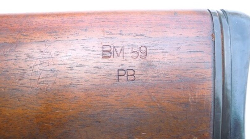 Factory markings on the stock of a Beretta BM59 rifle