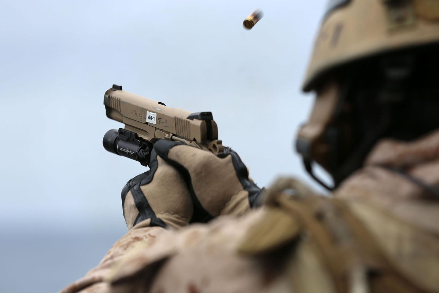 A Marine with the Maritime Raid Force, 11th Marine Expeditionary Unit, engages a target during a live fire training exercise with a Colt M45A1 CQBP pistol