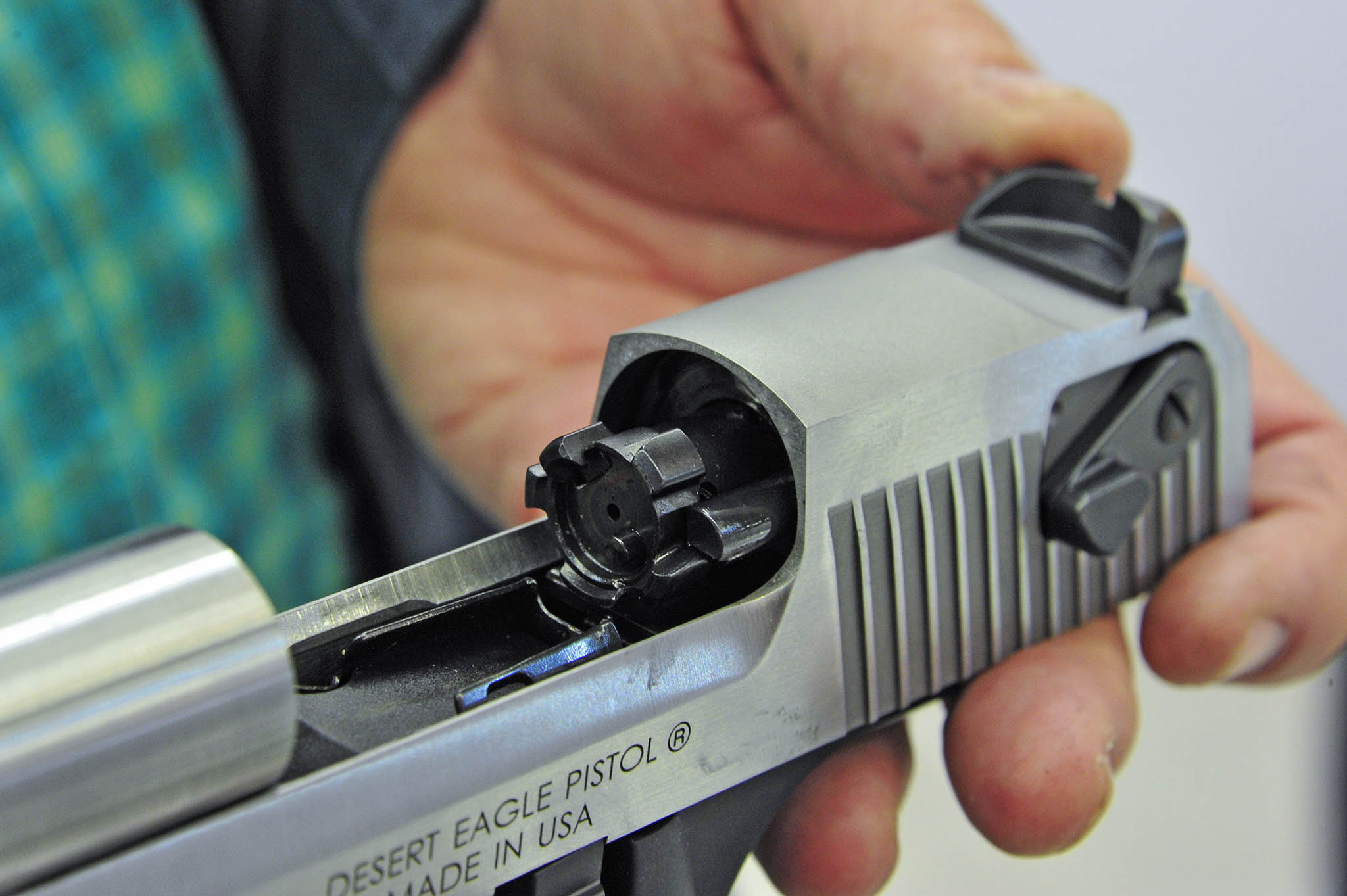 Why do most modern handguns use Browning's tilting barrel action